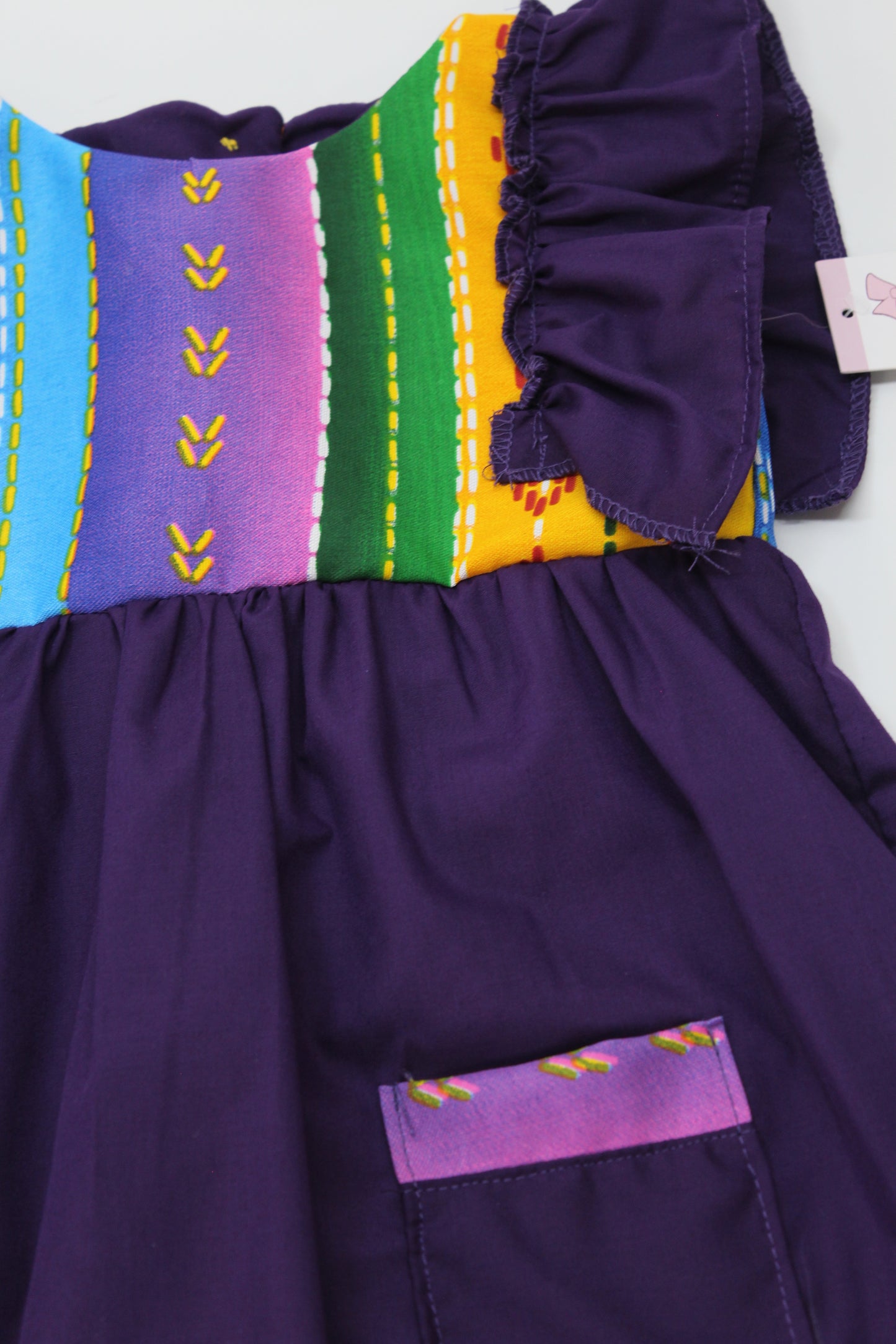 vestido patrio popelina morado con peto a rayas colores azul, amarillo, verde