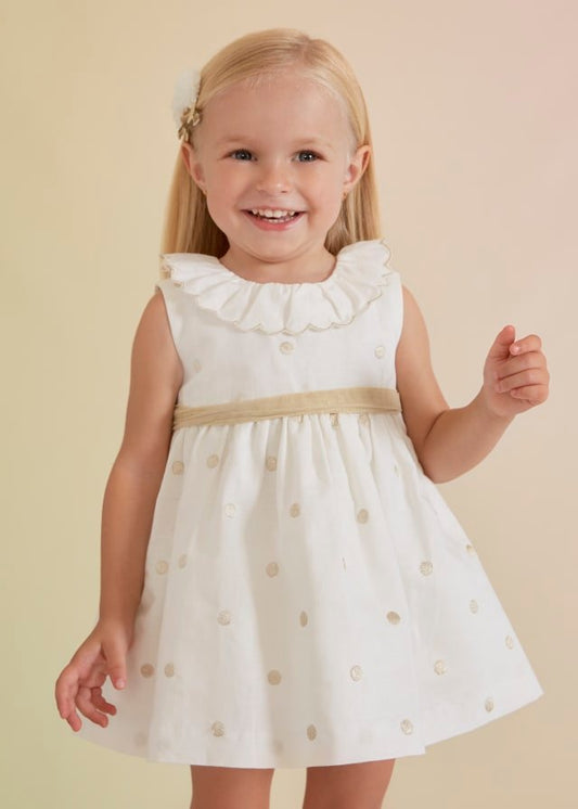 vestido de lino con lunares dorados para bebé.
