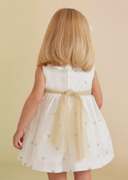 vestido de lino con lunares dorados para bebé.