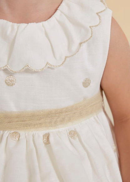 vestido de lino con lunares dorados para bebé.